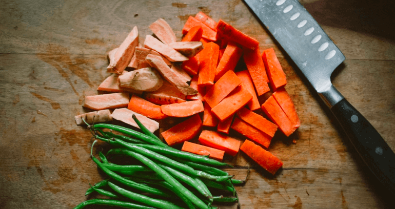 carrots & chilies along with knife on cutting board