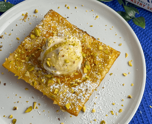 Nectarine Tarts garnished with chopped nuts & topped with ice cream served in a plate