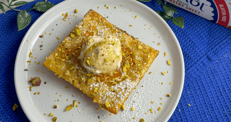 Nectarine Tarts garnished with chopped nuts & topped with ice cream served in a plate