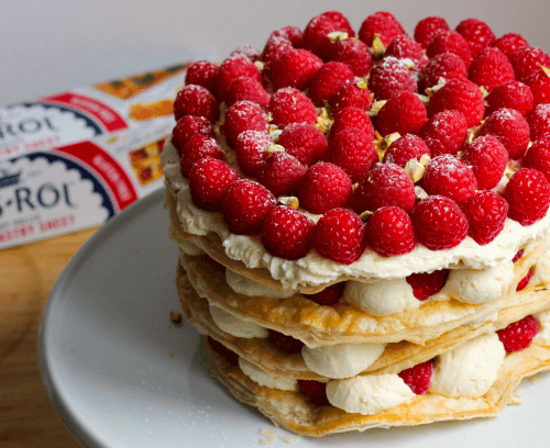 Raspberry & Pistachio Millefeuille Cake served in white plate