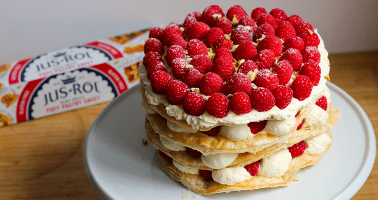 Raspberry & Pistachio Millefeuille Cake served in white plate